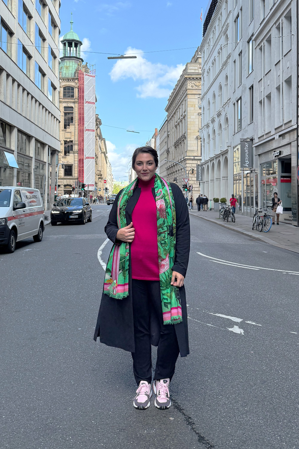 Frau in farbenfrohem Outfit auf einer Dortmunder Einkaufsstraße, mode für mollige dortmund in modernem, selbstbewusstem Look.